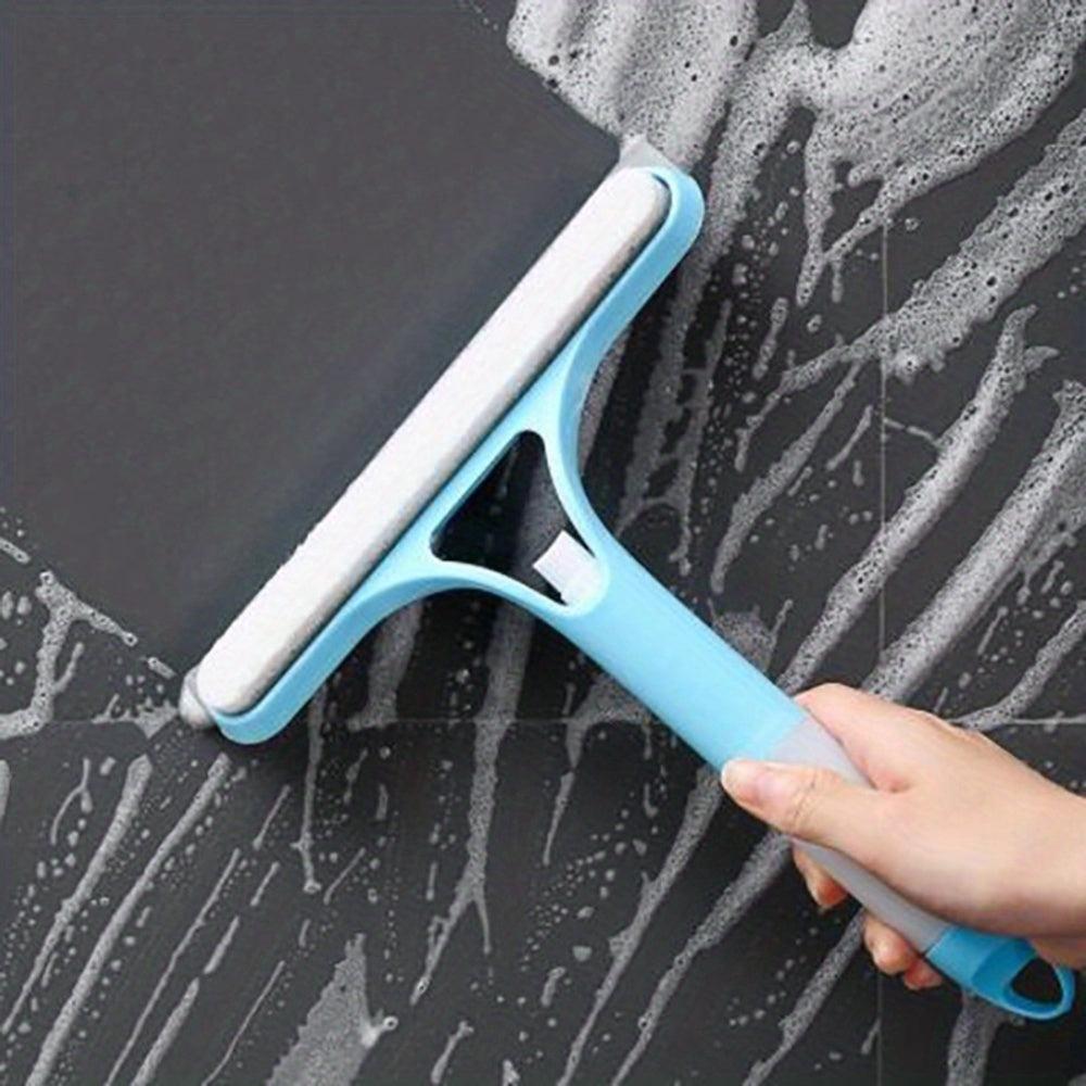Hand using 3-in-1 window squeegee with sponge to scrub soapy tile surface