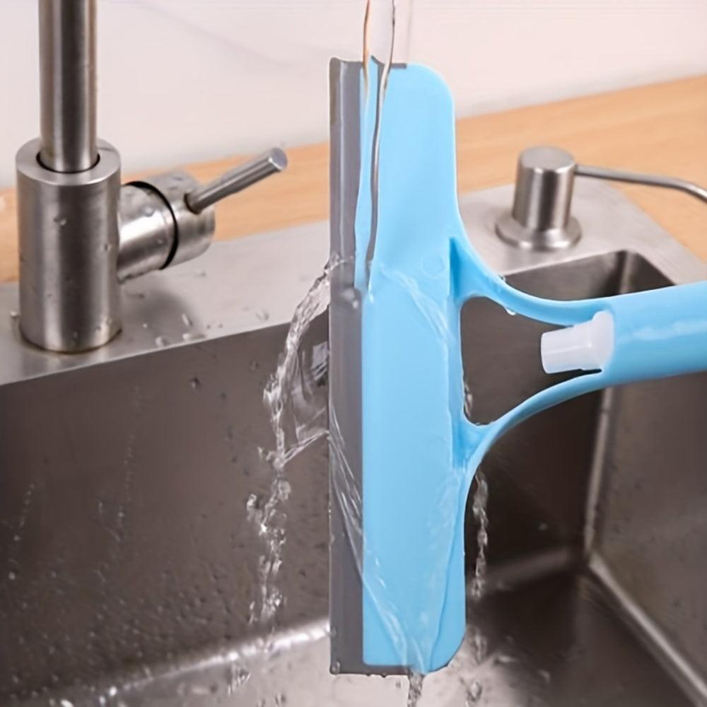 Rinsing 3-in-1 window squeegee under running water in kitchen sink