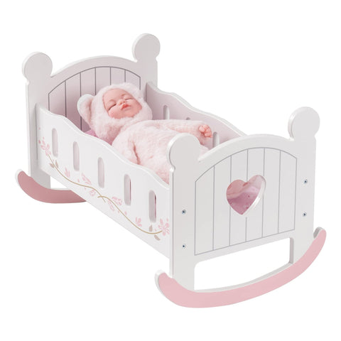 White and pink wooden rocking doll cradle with heart cutouts and a sleeping doll in a fuzzy outfit